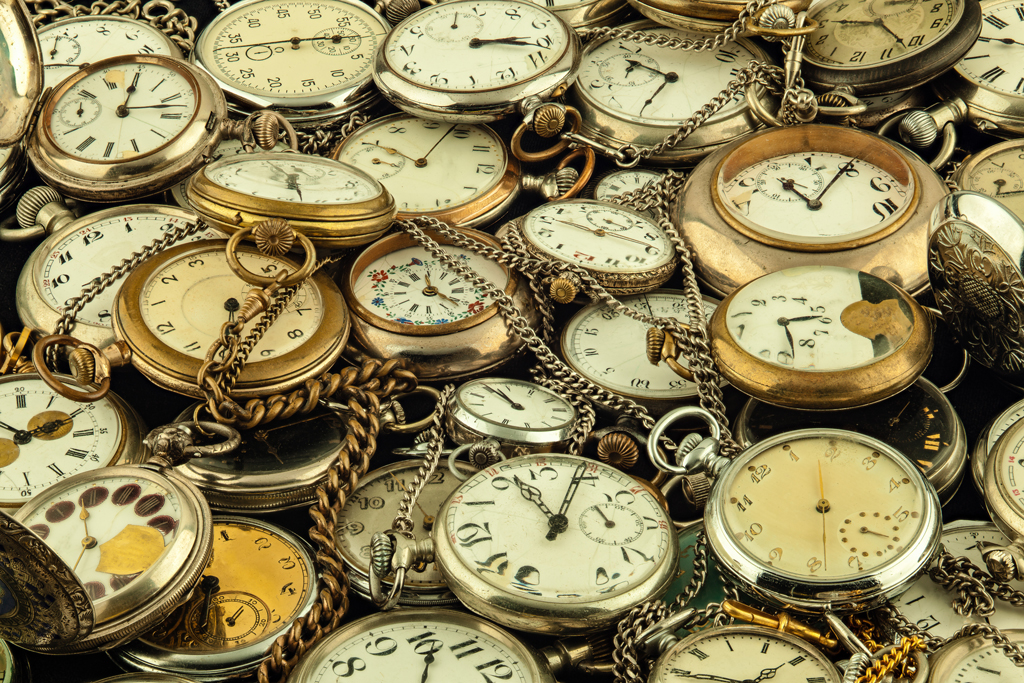 Photo of many antique pocket watches.